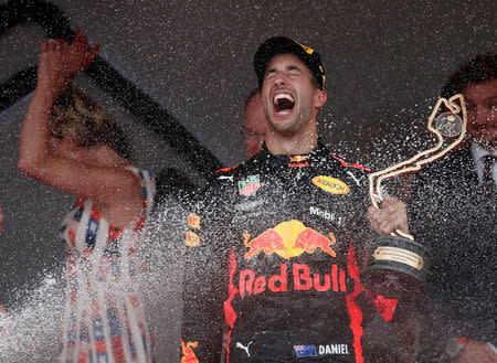 Formula One F1 - Monaco Grand Prix - Circuit de Monaco, Monte Carlo, Monaco - May 27, 2018 Red Bull’s Daniel Ricciardo celebrates winning the race with with the trophy while Prince Albert II of Monaco and Charlene, Princess of Monaco look on REUTERS/Benoit Tessier