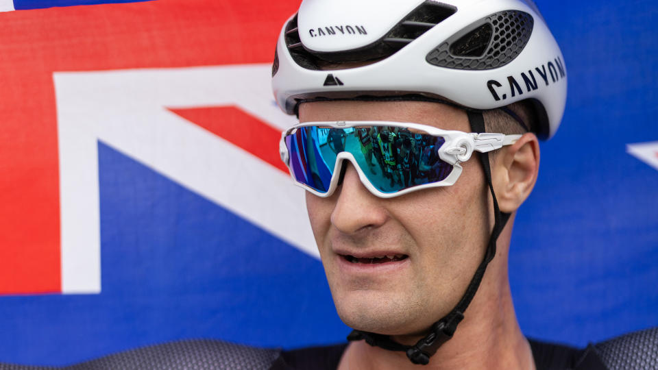 Sam Gaze celebrates with New Zealand flag after winning the 2023 XCC world champs