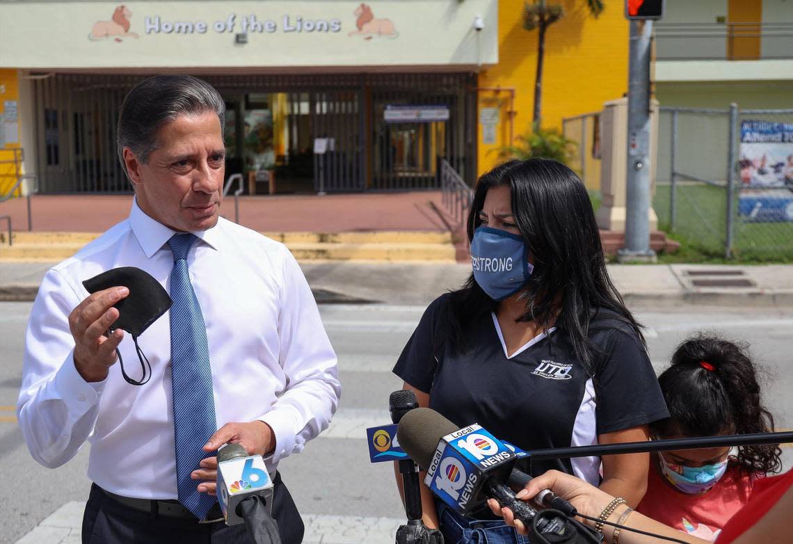 Miami-Dade County Public Schools Superintendent Alberto Carvalho, left, emphasizes the importance of mask wearing and vaccinating against COVID-19 as United Teachers of Dade President Karla Hernandez-Mats, center, and her daughter, Naomi Mats, 7, listen. On Tuesday, Sept. 7, the United Teachers of Dade, the teachers’ union for Miami-Dade public schools, held a pop-up vaccine clinic at a school in Liberty City to raise awareness of the importance of vaccines. Thirteen employees of Miami-Dade Schools have died from COVID since the start of the school year in August. None were vaccinated.