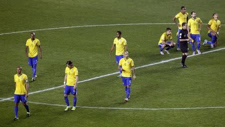 Brazil players walk off the pitch after losing to Paraguay in a penalty shootout in their Copa America 2015 quarter-finals soccer match at Estadio Municipal Alcaldesa Ester Roa Rebolledo in Concepcion, Chile, June 27, 2015. REUTERS/Jorge Adorno