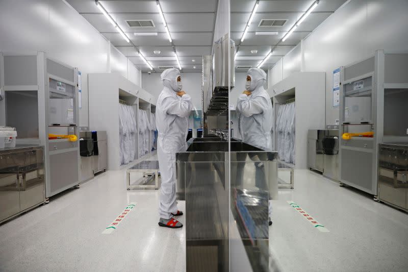 An employee wears cleanroom garment before getting into a clean room of National Nanofab Center in Daejeon