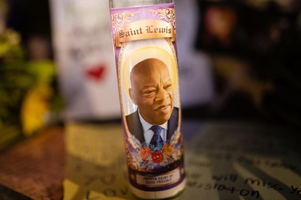 A candle for "Saint Lewis, Patron Saint of Good Trouble" is seen at a makeshift memorial for U.S. Rep John Lewis on July 19, 2020 in Atlanta.
