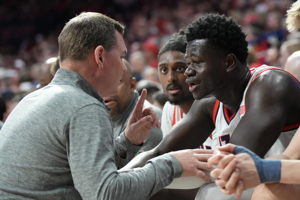 Arizona head coach Tommy Lloyd, left, talks to center Oumar Ballo during the first half of an NCAA college basketball game against Oregon State, Saturday, Feb. 4, 2023, in Tucson, Ariz. (AP Photo/Rick Scuteri)