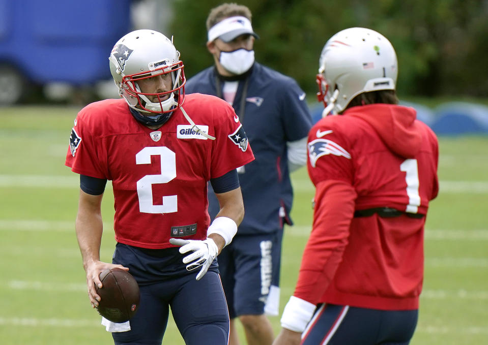 Brian Hoyer, left, and Cam Newton, right, are receiving nearly equal reps (with Jarrett Stidham) in a battle for the New England Patriots' QB job. (Photo by Steven Senne-Pool/Getty Images)