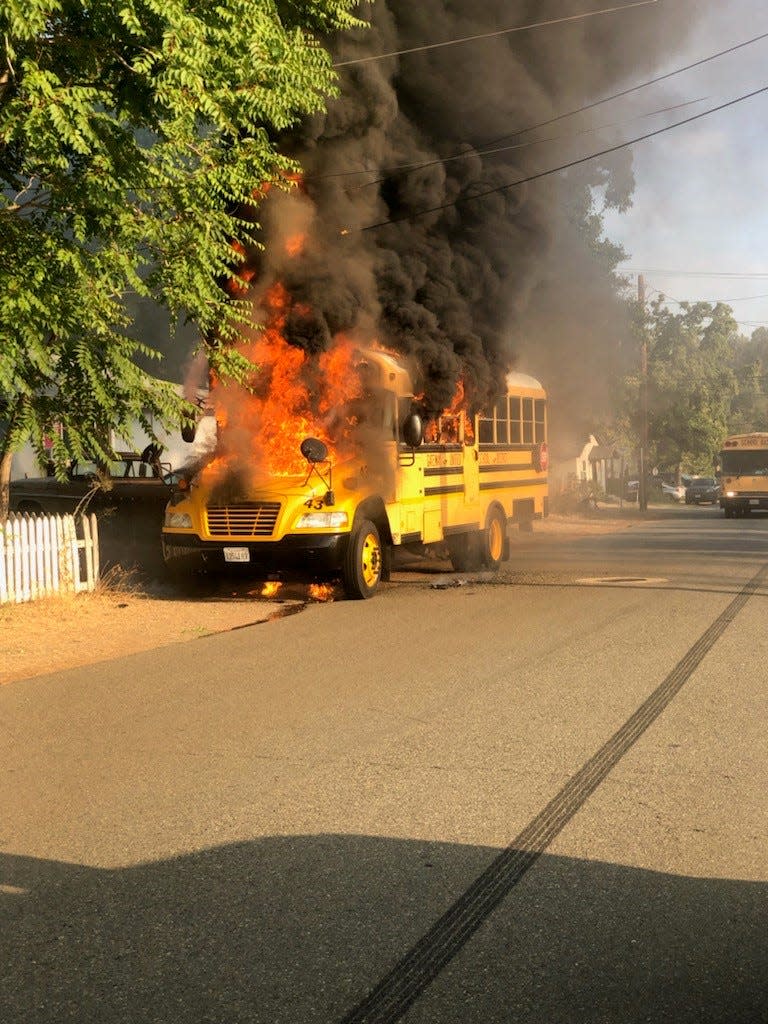 A school bus is engulfed in flames in the city of Shasta Lake on Wednesday morning, Aug. 16, 2023.