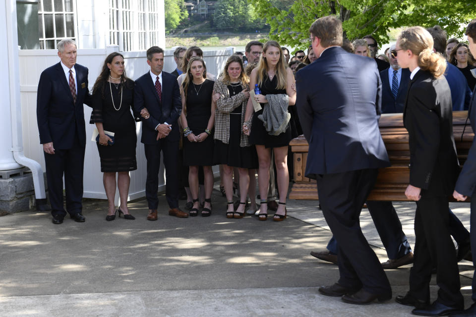 Parents of Riley Howell, Thomas and Natalie Henry-Howell, second from left, sister, Iris, fourth from left, girlfriend, Lauren Westmoreland and sister, Juliet watch the casket of Riley being carried in to the Stuart Auditorium for a memorial service for in Lake Junaluska, N.C., Sunday, May 5, 2019. Family and hundreds of friends and neighbors are remembering Howell, a North Carolina college student credited with saving classmates' lives by rushing a gunman firing inside their lecture hall. (AP Photo/Kathy Kmonicek)