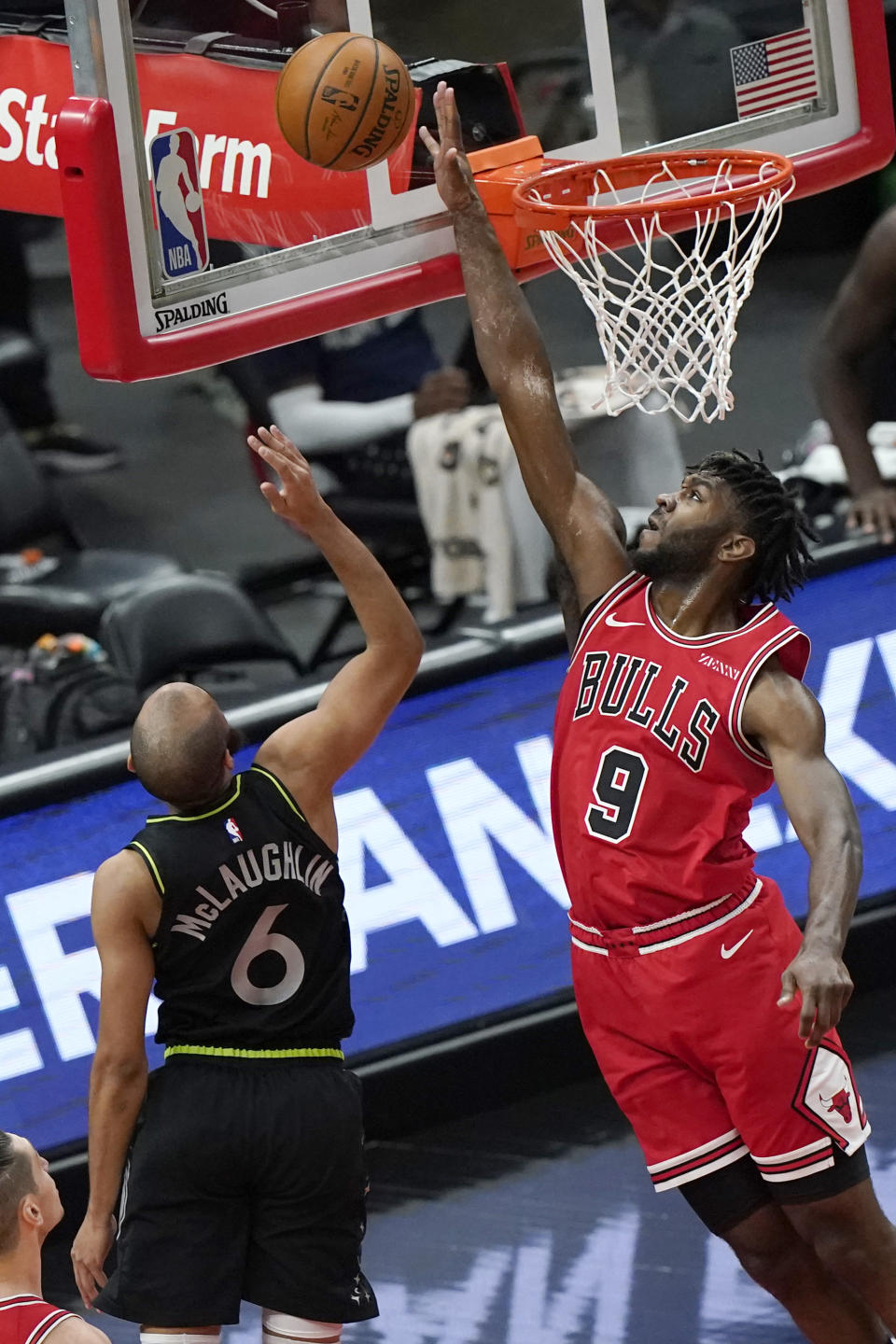 Chicago Bulls forward Patrick Williams, right, blocks a shot by Minnesota Timberwolves guard Jordan McLaughlin during the first half of an NBA basketball game in Chicago, Wednesday, Feb. 24, 2021. (AP Photo/Nam Y. Huh)