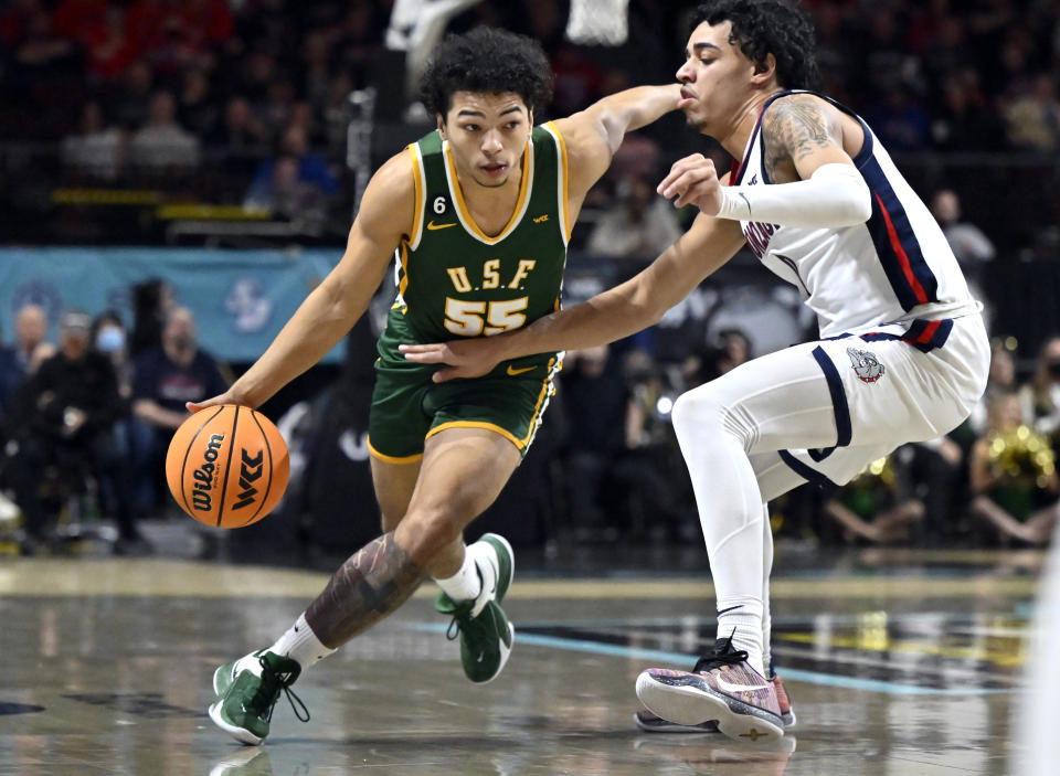 San Francisco guard Marcus Williams (55) drives the ball against Gonzaga guard Julian Strawther during the first half of an NCAA college basketball game in the semifinals of the West Coast Conference men's tournament Monday, March 6, 2023, in Las Vegas. (AP Photo/David Becker)