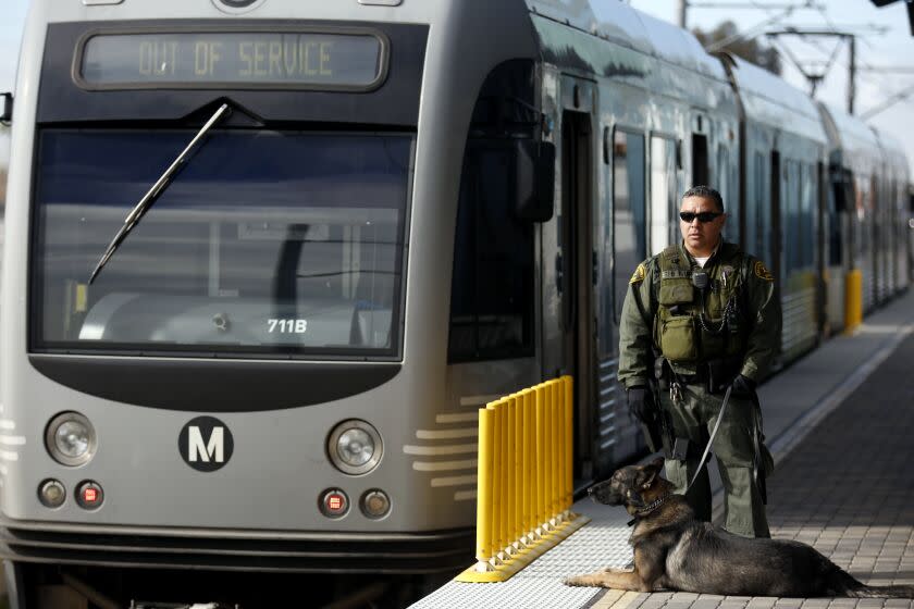 PASADENA, CA - DECEMBER 28, 2015: Los Angeles County Sheriff Mark Carrillo, and his dog "Benni" age 3, stand guard on the Metro Rail platform at the Sierra Madre Villa Station in Pasadena, CA in the cold temperature December 28, 2015. (Francine Orr/ Los Angeles Times)