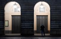 A person wearing a face mask is seen at the entrance of the Teatro alla Scala as the spread of coronavirus disease (COVID-19) continues, in Milan