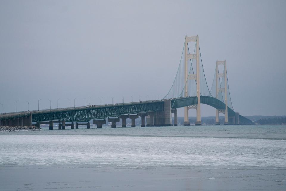 The Mackinac Bridge sits in the background with a barely frozen Lake Michigan on Friday, Jan. 5, 2024.The lack of snow has affected winter sports tourism in the Upper Peninsula.