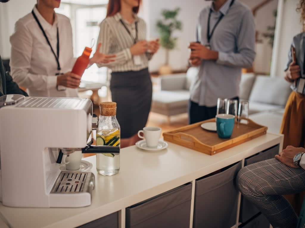 A group of people take a coffee break at work (Getty Images)