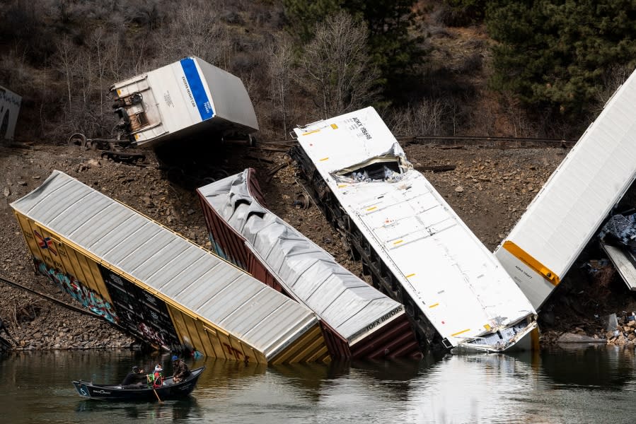 A group of fishermen float on the Clark Fork River near a derailed train, west of St. Regis, Mont., Sunday, April 2, 2023. Montana Rail Link is investigating the derailment in which there were no injuries reported. (Ben Allan Smith/The Missoulian via AP)