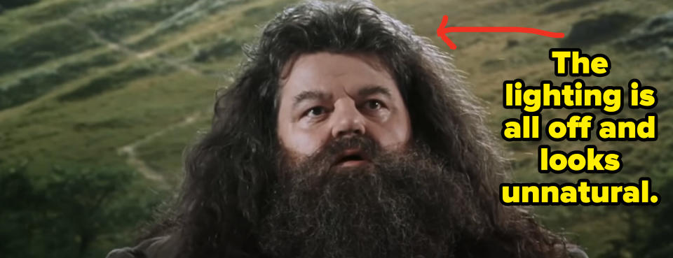 Hagrid stands in front of a fake background