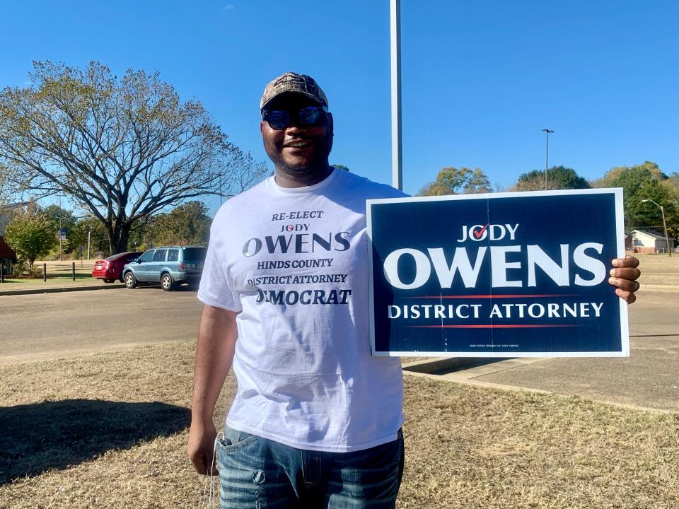 Eric Brown, a campaigner for the re-election of Hinds County District Attorney Jody Owens, encourages people to vote on Tuesday at Blackburn Middle School in Jackson.