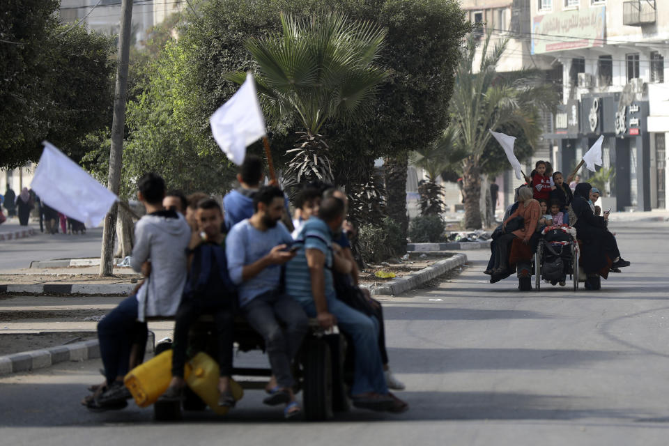 Palestinians on donkey carts hold up white flags trying to prevent being shot, while fleeing Gaza City on the al-Rimal neighbourhood, central Gaza City, Wednesday, Nov. 8, 2023. (AP Photo/Abed Khaled)