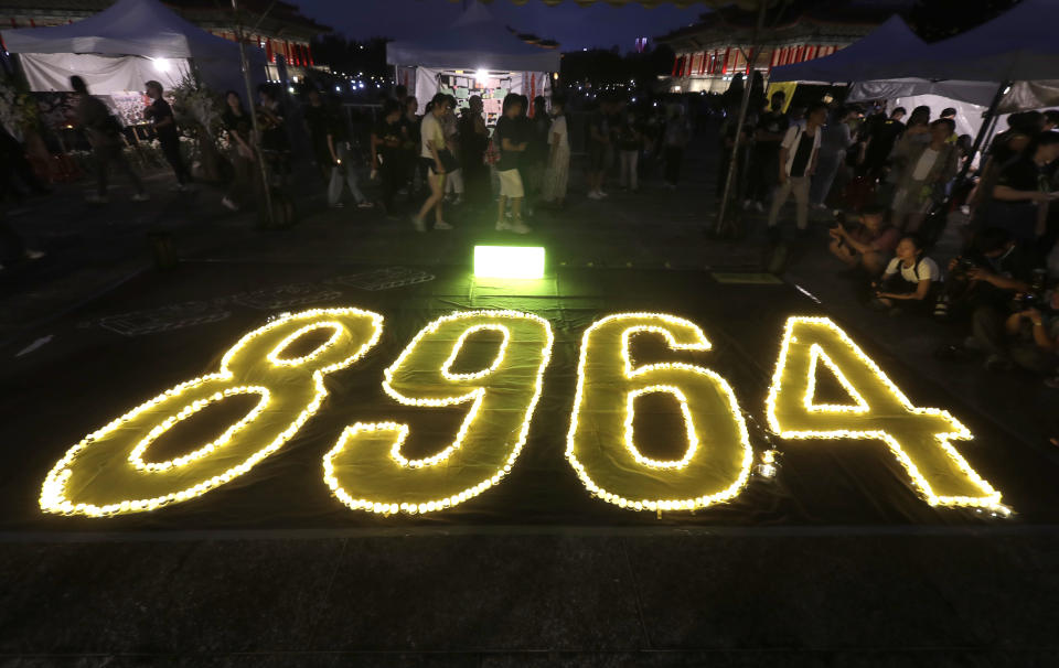 Hundreds of participants attend a candlelight vigil at Democracy Square in Taipei, Taiwan, Sunday, June 4, 2023, to mark the 34th anniversary of the Chinese military crackdown on the pro-democracy movement in Beijing's Tiananmen Square. (AP Photo/Chiang Ying-ying)