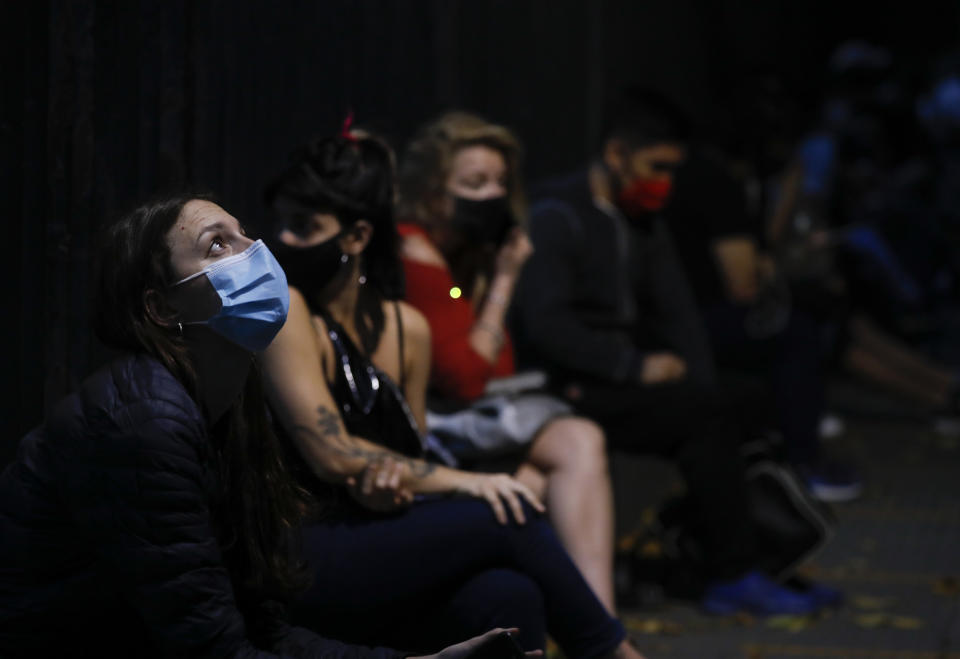 People wait their turn to get tested for COVID-19 outside a hospital in Buenos Aires, Argentina, Thursday, April 8, 2021. Argentina has issued a night-time lockdown starting Friday midnight to try to stop the increase of COVID-19 infections. (AP Photo/Natacha Pisarenko)