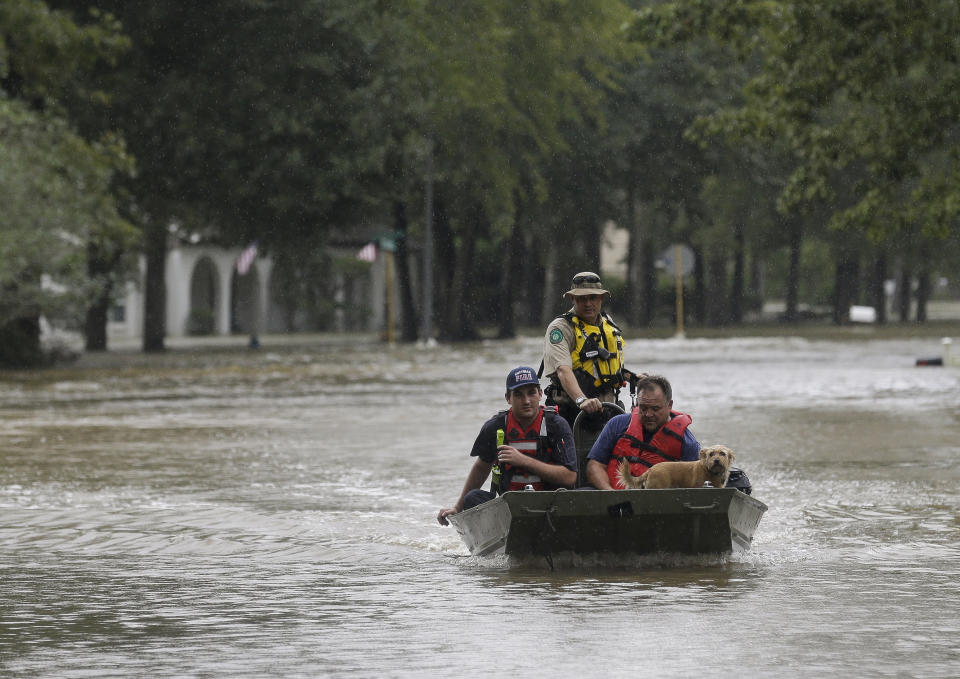 First responders with the Harris County Sheriff's Office, Texas Game Warden, and Huffman Fire Department rescued people from flooded homes in the Lochshire neighborhood Friday, Sept. 20, 2019, in Huffman, Texas. The Luce Bayou overflowed due to the heavy rain during Tropical Storm Imelda. (Godofredo A. Vasquez/Houston Chronicle via AP)