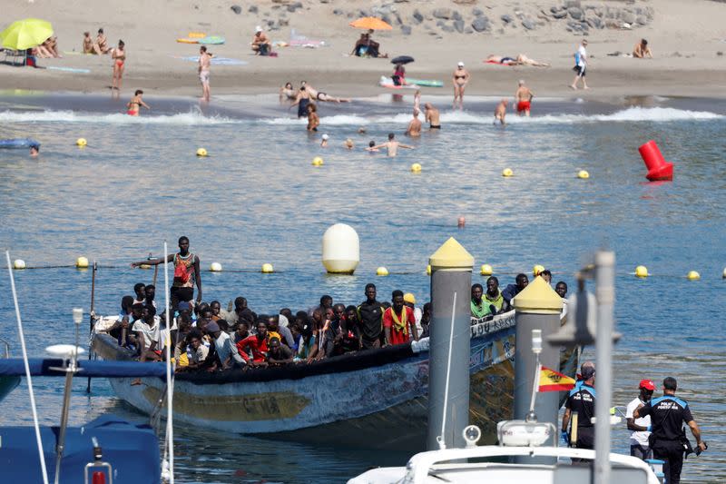 Migrants arrive on a wooden boat to the port of Los Cristianos in the south of the island of Tenerife