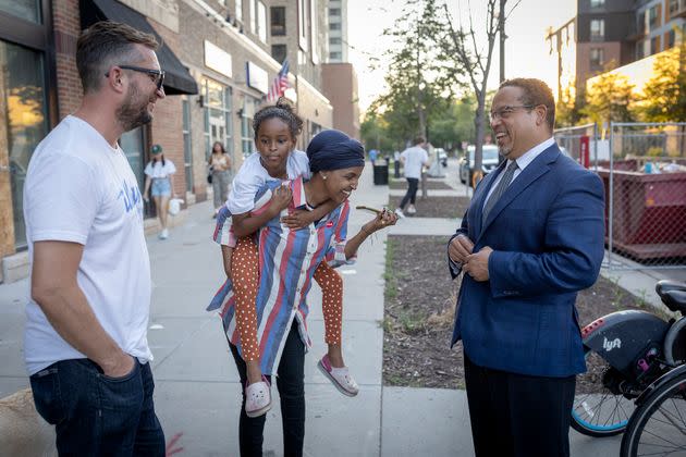 Democratic Rep. Ilhan Omar of Minnesota (center) talks to Ellison on the day of primary voting in August. Omar nearly lost to a challenger who criticized her support for radical policing policies. (Photo: Star Tribune/Getty Images)