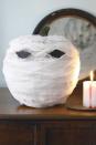 <p>Wrap a pumpkin in cheesecloth to create an ominous-looking mummy's head. Black construction-paper eyes add to the eerie image.</p><p>Get the <a href="https://www.womansday.com/home/crafts-projects/how-to/a5999/craft-project-menacing-mummy-123881/" rel="nofollow noopener" target="_blank" data-ylk="slk:Menacing Mummy Pumpkin tutorial;elm:context_link;itc:0;sec:content-canvas" class="link "><strong>Menacing Mummy Pumpkin tutorial</strong></a>.</p><p><a class="link " href="https://www.amazon.com/Majestic-NATURAL-CHEESECLOTH-Natural-Cotton/dp/B00IT69HYW?tag=syn-yahoo-20&ascsubtag=%5Bartid%7C10070.g.331%5Bsrc%7Cyahoo-us" rel="nofollow noopener" target="_blank" data-ylk="slk:SHOP CHEESECLOTH;elm:context_link;itc:0;sec:content-canvas">SHOP CHEESECLOTH</a></p>