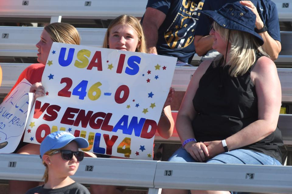 A young fan shows off a sign before the United States and England squared off in pool play on July 4 at  the 2022 World Lacrosse Women's Championship in Towson, Maryland