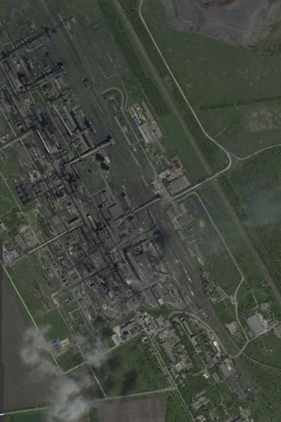 This satellite image from May 20, 2021 shows Avdiivka's coke plant before Russia's full-scale invasion of Ukraine. The loss of the city of Avdiivka in February, 2024 marked the end of a long, exhausting defense for the Ukrainian military. One brigade had defended the same block of buildings for months without a break. (Planet Labs via AP)