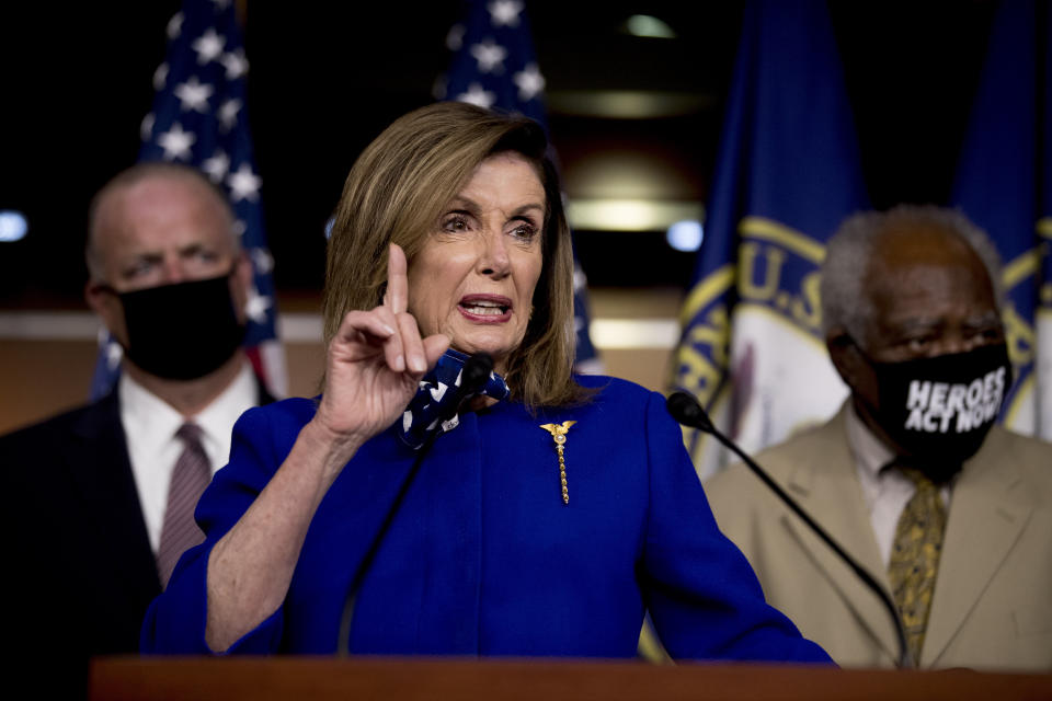 House Speaker Nancy Pelosi of Calif., accompanied by Rep. Dan Kildee, D-Mich., left, and Rep. Danny Davis, D-Ill., right, speaks at a news conference on Capitol Hill in Washington, Friday, July 24, 2020, on the extension of federal unemployment benefits. (AP Photo/Andrew Harnik)