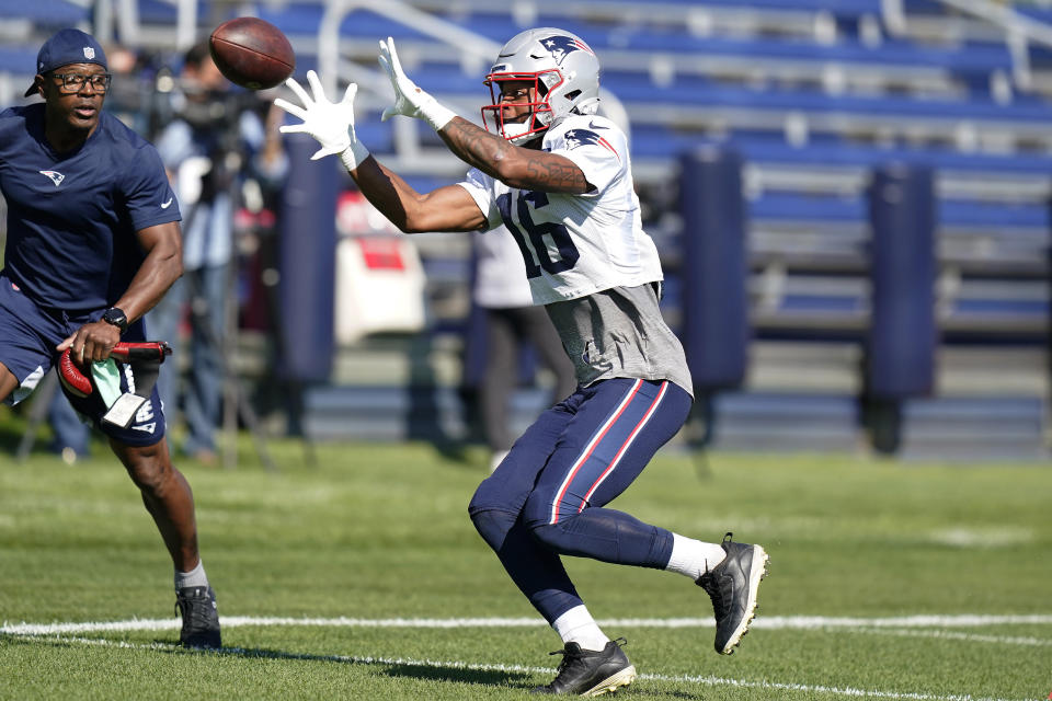 FILE - New England Patriots wide receiver Jakobi Meyers (16) makes a catch as running backs and kick returners coach Troy Brown, left, looks on during an NFL football practice, Wednesday, Oct. 13, 2021, in Foxborough, Mass. The Patriots are one of the NFL’s most successful franchises, winning six Super Bowls. But they, like many NFL teams, have a less than impressive record when it comes to hiring minority assistant coaches. (AP Photo/Steven Senne, File)