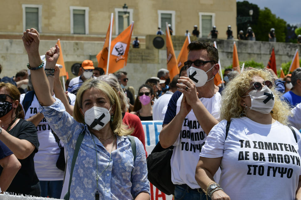 Protesters take part in a rally during a 24-hour labor strike, in Athens, Thursday, June 10, 2021. Widespread strikes in Greece brought public transport and other services to a halt Thursday, as the country's largest labor unions protested against employment reforms they argue will make flexible workplace changes introduced during the pandemic more permanent. (AP Photo/Michael Varaklas)