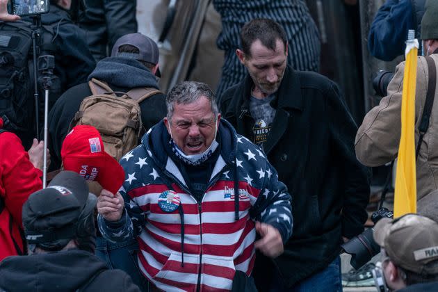 HuffPost identified Robert Scott Palmer (center) as a member of the pro-Trump crowd that stormed the U.S. Capitol on Jan. 6. He was filmed assaulting police with a fire extinguisher. (Photo: Lev Radin/Pacific Press/Shutterstock)