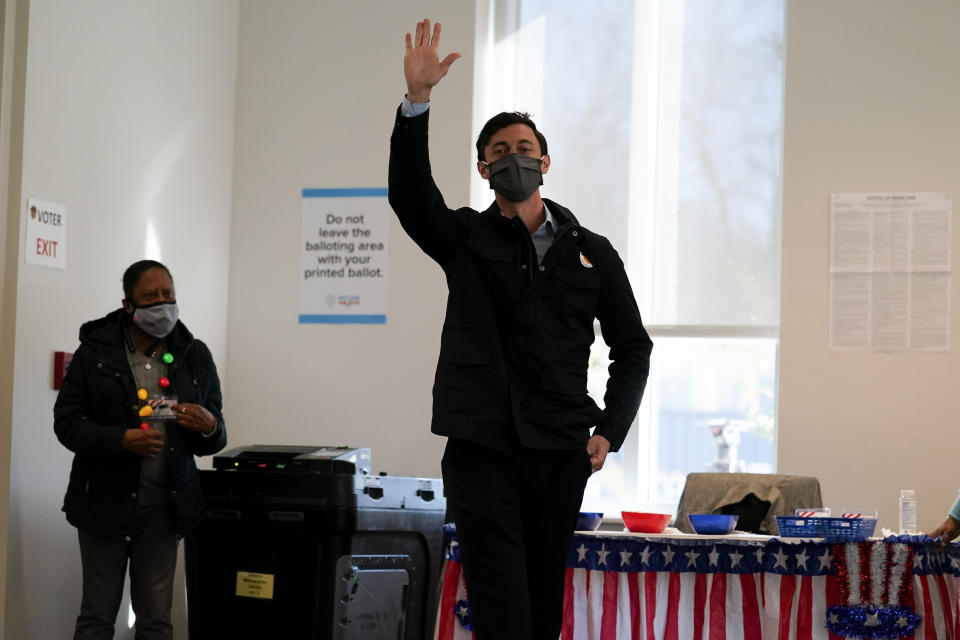 Democratic U.S. Senate challenger from Georgia Jon Ossoff waves after voting early in Atlanta on Tuesday, Dec. 22, 2020. (AP Photo/John Bazemore)