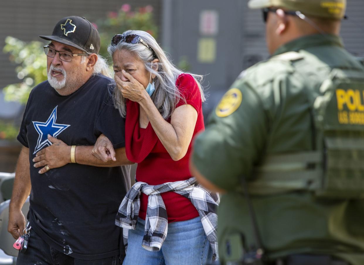 A woman cries as she leaves the Uvalde Civic Center on Tuesday, May 24, 2022, in Uvalde, Texas, after an 18-year-old gunman opened fire Tuesday at a Texas elementary school. 