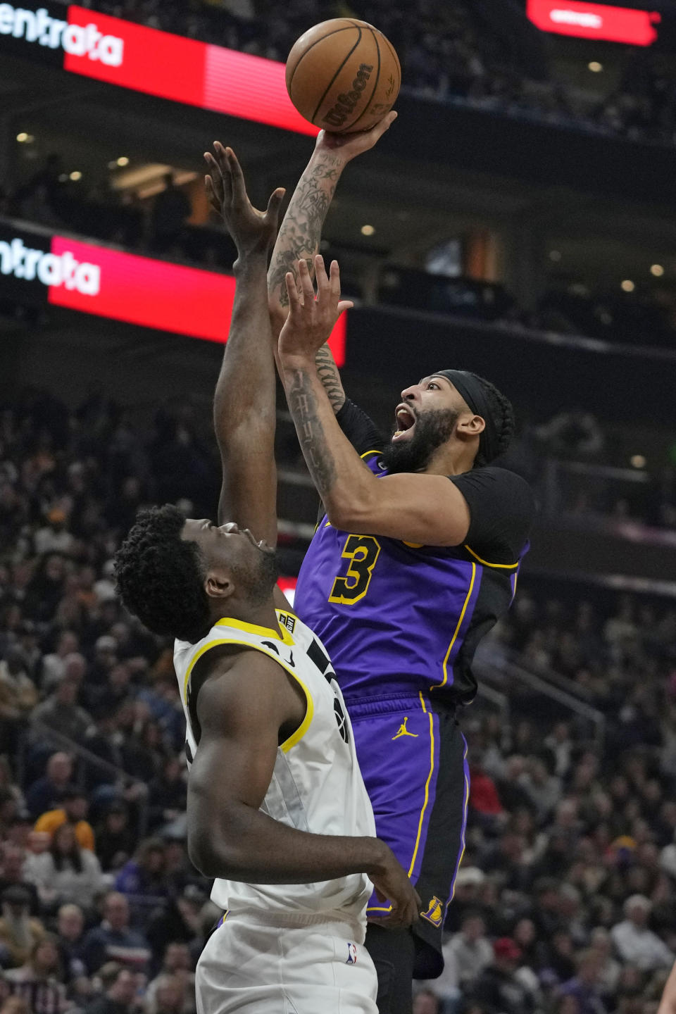 Los Angeles Lakers forward Anthony Davis (3) shoots as Utah Jazz center Udoka Azubuike, left, during the first half of an NBA basketball game Tuesday, April 4, 2023, in Salt Lake City. (AP Photo/Rick Bowmer)