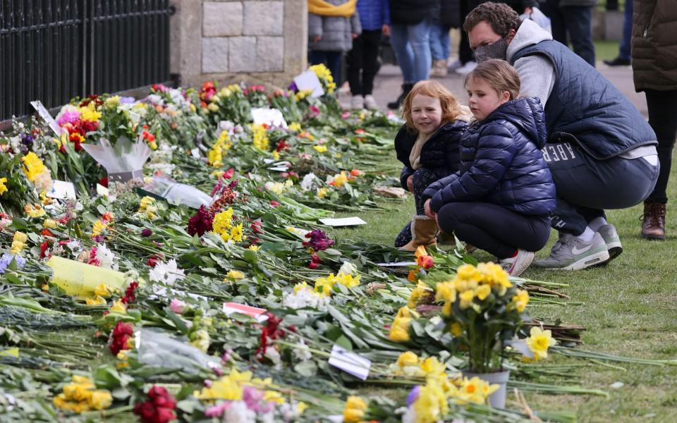 Members of the public leave floral tributes to Prince Philip, Duke Of Edinburgh who died at age 99 outside of Windsor Castle on April 11 - Chris Jackson/Getty