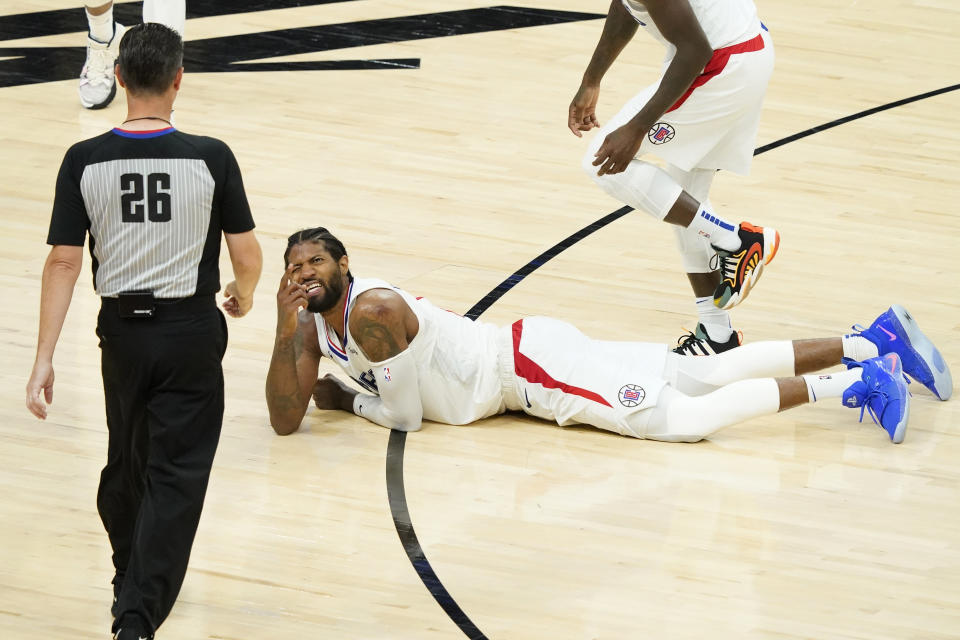 Los Angeles Clippers guard Paul George looks for a foul call from referee Pat Fraher (26) during the second half of game 5 of the NBA basketball Western Conference Finals against the Phoenix Suns, Monday, June 28, 2021, in Phoenix. (AP Photo/Matt York)