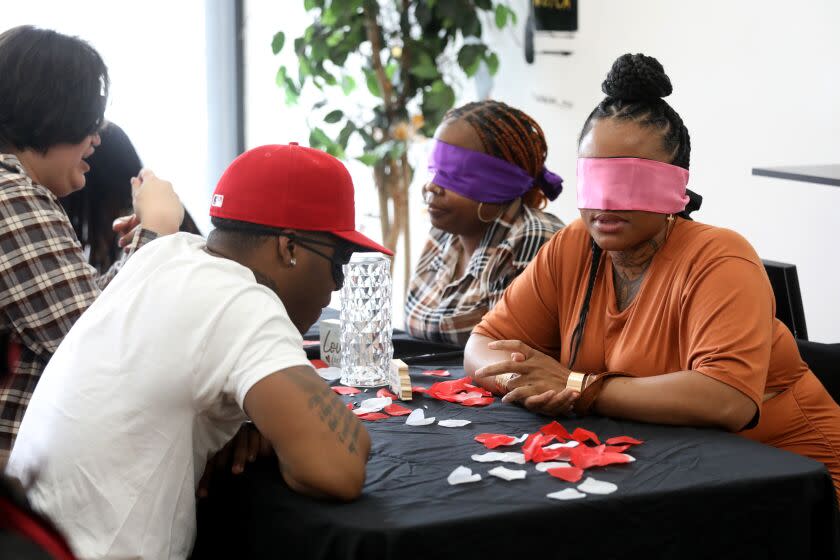 LOS ANGELES, CA - APRIL 29: Left to right, Joseph Jessup, of Burbank, music artist Head, of St. Louis, Jessica Holmes, of Compton, and Ashley Franklin, of Anaheim, at a blindfolded speed dating event at the New Millenium Beauty and Barber Shops on Saturday, April 29, 2023 in Los Angeles, CA. Miss Haze began hosting blindfolded speed dating events in her hometown of St. Louis before "Love is Blind" blew up on Netflix. Now, she's bringing the experience to L.A. for the first time. (Gary Coronado / Los Angeles Times)