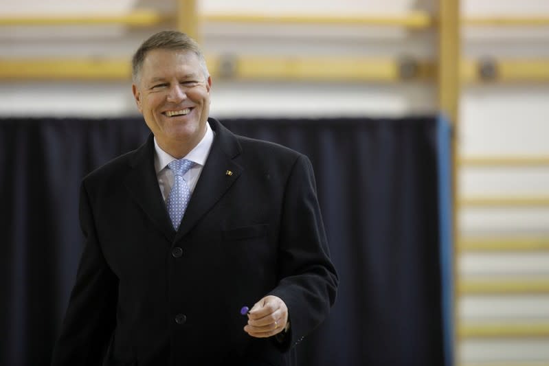 Incumbent candidate Klaus Iohannis reacts after casting his ballot in the second round of a presidential election