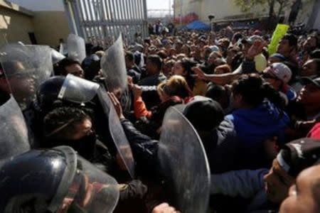 Family members of inmates clash with police blocking the entrance of the Topo Chico prison in Monterrey, Mexico, February 11, 2016. REUTERS/Daniel Becerril