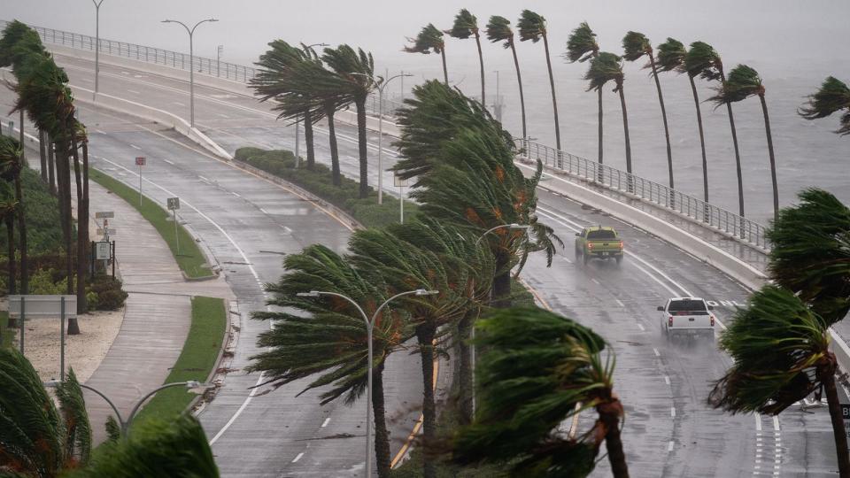 Motorists travel across the John Ringling Causeway as Hurricane Ian churns to the south on September 28, 2022 in Sarasota, Florida. The storm made a U.S. landfall at Cayo Costa, Florida this afternoon as a Category 4 hurricane with wind speeds over 140 miles per hour in some areas.