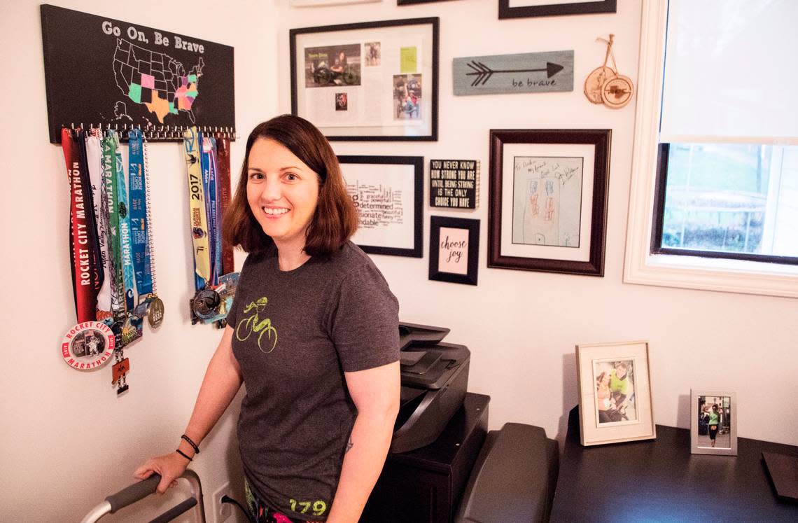 Andrea Peet poses for a portrait, with just a handful of her racing medals, at her home in Raleigh, N.C. on Feb. 13, 2020. Peet was diagnosed with ALS in 2014. As an avid marathon runner and triathlete, she has pushed through the physical struggles brought on by the disease to continue racing on a recumbent trike. Her foundation, Team Drea, has raised over $500,000 for ALS research and she participates in multiple ongoing studies. After passing a milestone of five years living with ALS, Peet decided she wanted to participate in a race in all 50 states. To date, she has completed 20 races.