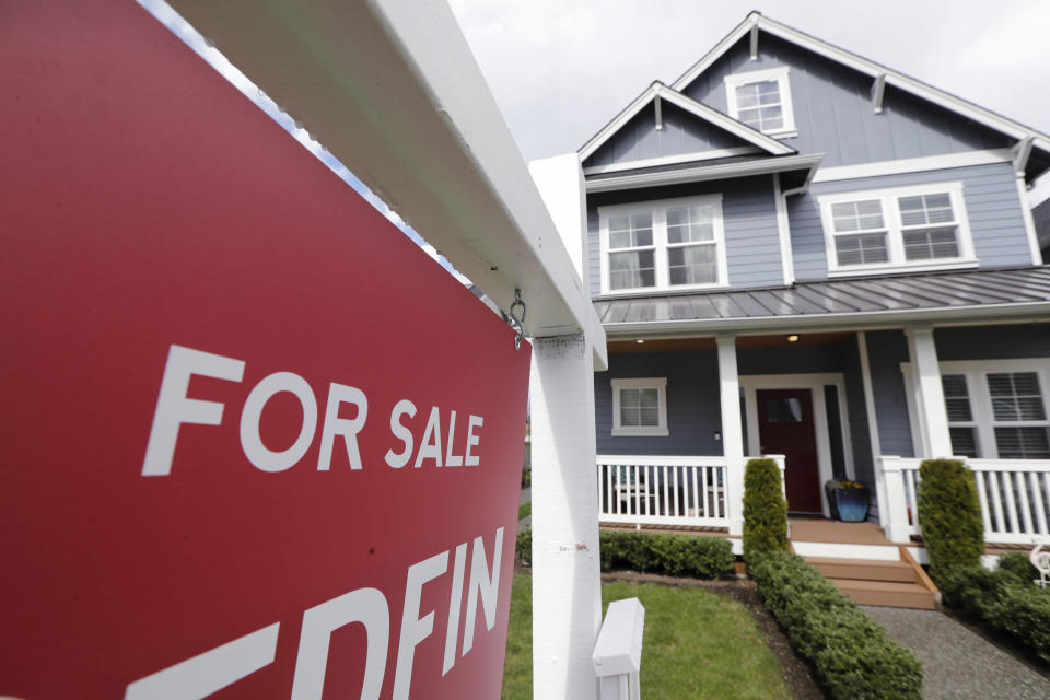 FILE - In this April 1, 2020 photo, a "For Sale" sign stands in front of a home that is in the process of being sold in Monroe, Wash., outside of Seattle. Sales of new homes jumped again in July, rising 13.9% as the housing market continues to gain traction following a spring downturn caused by pandemic-related lockdowns. The Commerce Department reported Tuesday, Aug. 25, that July’s gain propelled sales of new homes to a seasonally-adjusted annual rate of 901,000. (AP Photo/Elaine Thompson, File)