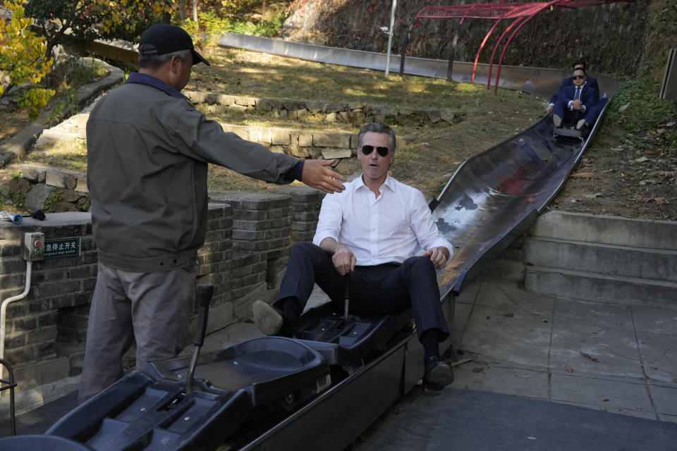 California Gov. Gavin Newsom gets off a slideway during a visit to the Mutianyu Great Wall on the outskirts of Beijing, Thursday, Oct. 26, 2023. Newsom is on a weeklong tour of China where he is pushing for climate cooperation. His trip as governor, once considered routine, is drawing attention as it comes after years of heightening tensions between the U.S. and China. (AP Photo/Ng Han Guan)