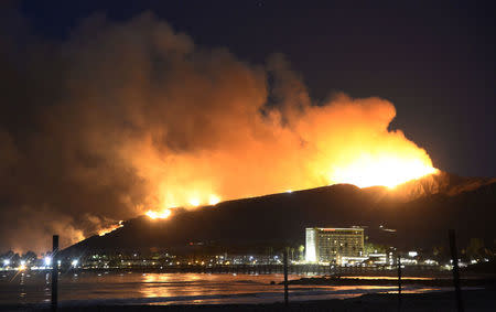 Huge flames light up the coast line the Solimar brush fire that started early Saturday morning in Ventura County, California December 26, 2015. REUTERS/Gene Blevins