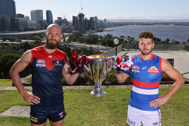 Pictured here, Demons captain Max Gawn and Bulldogs opposite Marcus Bontempelli pose with the AFL trophy.