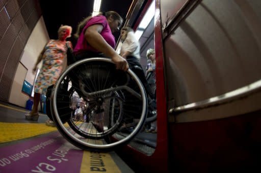 Brazilian Viviane Macedo, 35, gets in a metro car at a station in Rio de Janeiro. Challenges facing the disabled here run the gamut from subway elevators breaking down a lot, to sidewalks being uncommon, and often pocked with potholes