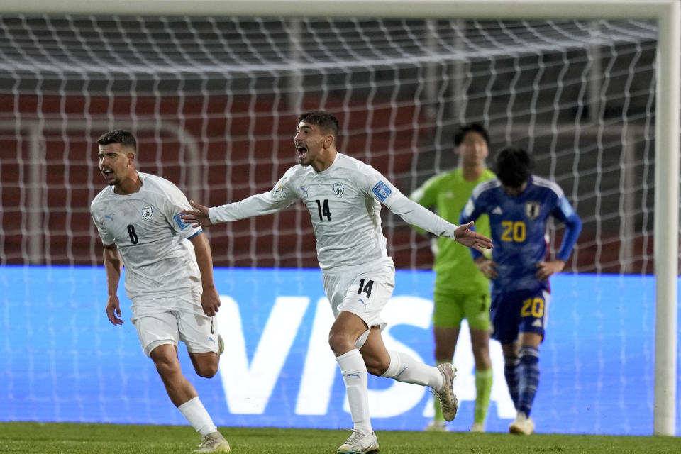 Israel's Roy Navi, center, celebrates scoring his side's first goal against Japan, during a FIFA U-20 World Cup Group C soccer match at the Malvinas Argentinas stadium in Mendoza, Argentina, Saturday, May 27, 2023. (AP Photo/Natacha Pisarenko)