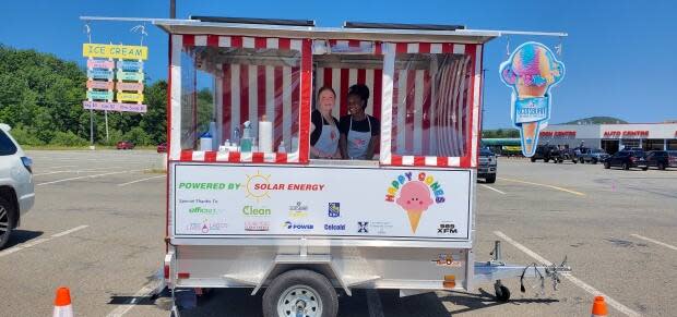 Nicky Nicholson, left, is seen with a co-worker inside the Happy Cones ice cream trailer. Nicholson opened the entirely solar-powered trailer in July. (Peter Nicholson - image credit)