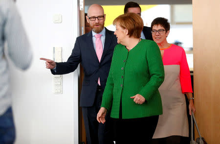 Secretary General of the Christian Democratic Union (CDU) Peter Tauber, German Chancellor Angela Merkel and Saarland State Prime Minister Annegret Kramp-Karrenbauer ahead CDU leadership meeting in Berlin, Germany, February 19, 2018. REUTERS/Hannibal Hanschke